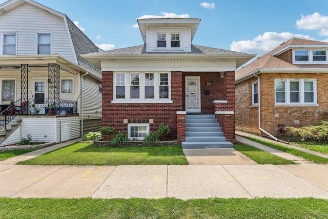 5639 W Cornelia Ave, Chicago, IL 60634 - view of front of home featuring brick siding, a porch, and a front lawn