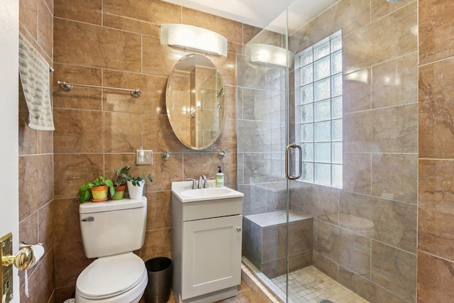5639 W Cornelia Ave, Chicago, IL 60634 - full bathroom with tile walls, vanity, a shower stall, and plenty of natural light