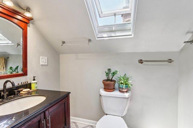 5639 W Cornelia Ave, Chicago, IL 60634 - half bath with a skylight, lofted ceiling, and vanity