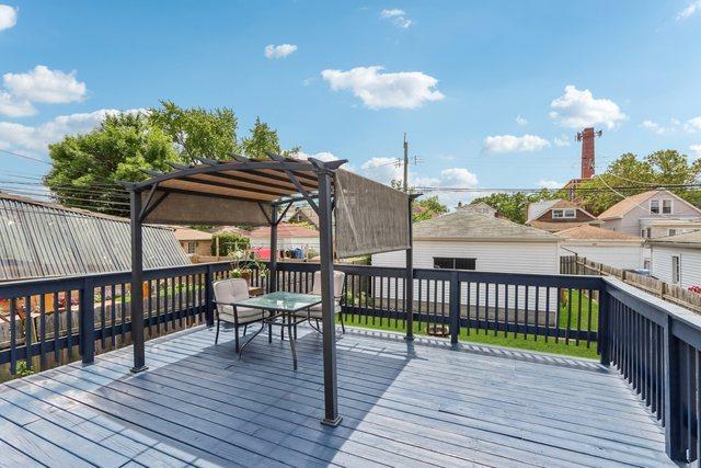 5639 W Cornelia Ave, Chicago, IL 60634 - wooden terrace featuring outdoor dining space, an outdoor structure, and a pergola