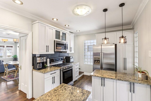 5639 W Cornelia Ave, Chicago, IL 60634 - kitchen with appliances with stainless steel finishes, white cabinets, dark wood-style floors, backsplash, and healthy amount of natural light