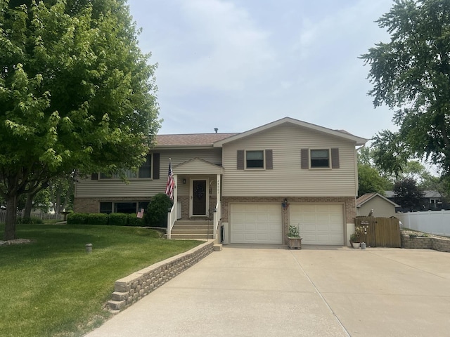 24005 S Green Heron Dr, Channahon, IL 60410 - split foyer home featuring brick siding, an attached garage, and concrete driveway