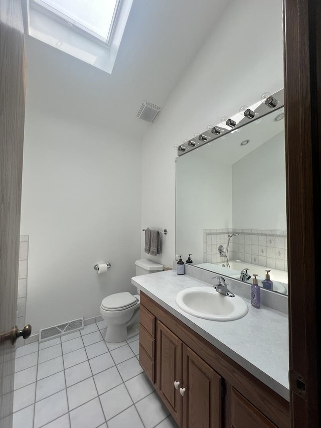 24005 S Green Heron Dr, Channahon, IL 60410 - bathroom with a skylight, vaulted ceiling, tile patterned flooring, vanity, and a bath
