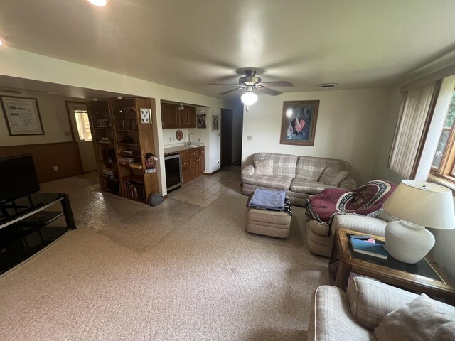 24005 S Green Heron Dr, Channahon, IL 60410 - tiled living room with bar with sink, a ceiling fan, and beverage cooler