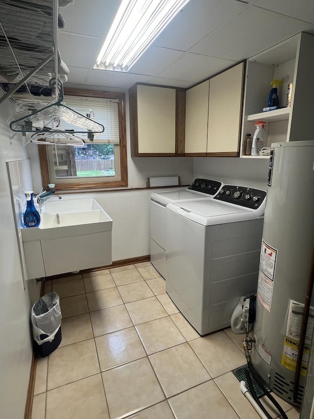 24005 S Green Heron Dr, Channahon, IL 60410 - washroom with gas water heater, washer and dryer, cabinet space, and light tile patterned flooring