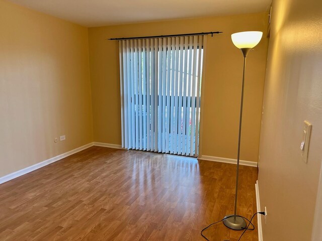 6162 Knollwood Rd Unit 202, Willowbrook, IL 60527 - unfurnished room featuring wood finished floors and baseboards