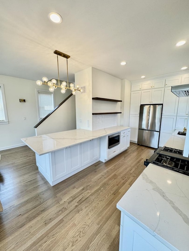 4030 N California Ave Unit 3, Chicago, IL 60618 - kitchen with open shelves, appliances with stainless steel finishes, light wood-type flooring, white cabinetry, and healthy amount of natural light
