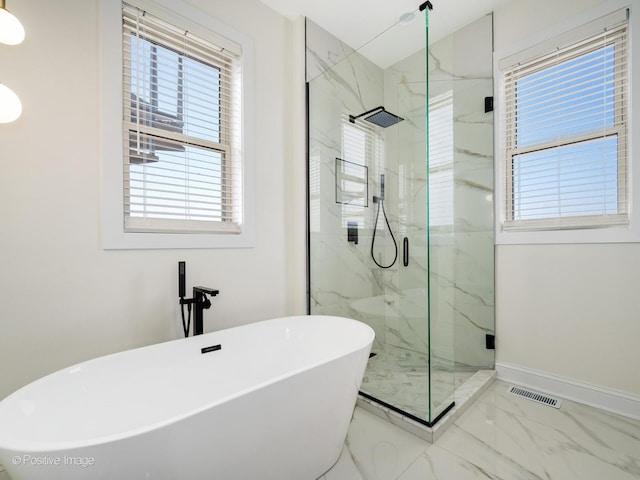 4030 N California Ave Unit 3, Chicago, IL 60618 - bathroom featuring marble look tiles, a freestanding bath, and a marble finish shower