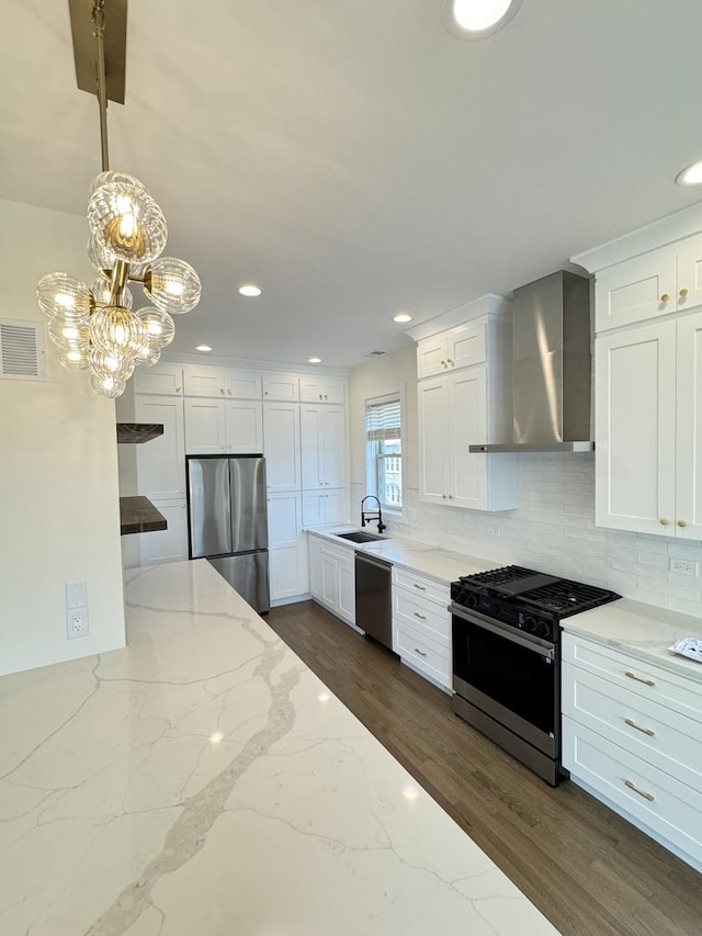 4030 N California Ave Unit 3, Chicago, IL 60618 - kitchen with stainless steel appliances, wall chimney range hood, white cabinetry, decorative backsplash, and recessed lighting