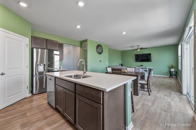 1360 Vineyard Ln, Pingree Grove, IL 60140 - kitchen featuring stainless steel fridge with ice dispenser, light wood finished floors, ceiling fan, an island with sink, and dishwashing machine
