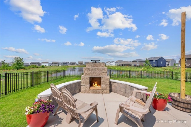 1360 Vineyard Ln, Pingree Grove, IL 60140 - fenced backyard featuring an outdoor stone fireplace, a residential view, a patio, and a water view