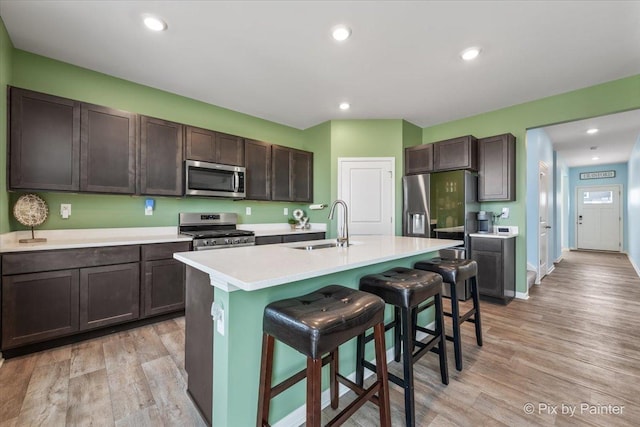 1360 Vineyard Ln, Pingree Grove, IL 60140 - kitchen with appliances with stainless steel finishes, a breakfast bar area, light wood-style flooring, light countertops, and recessed lighting
