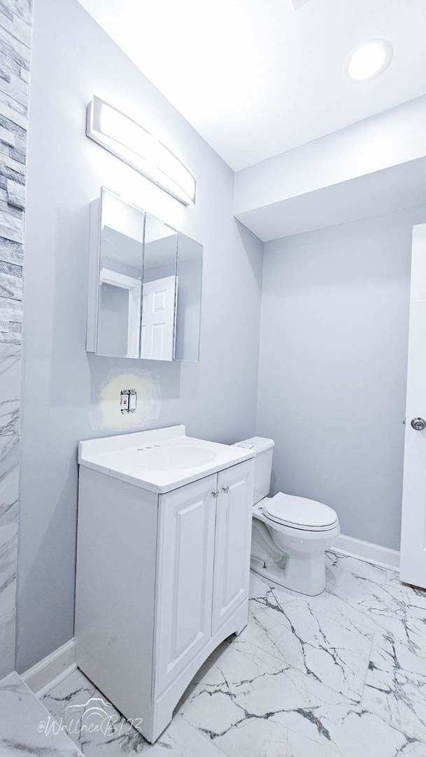 5309 S Bishop St, Chicago, IL 60609 - bathroom with marble finish flooring, vanity, and recessed lighting
