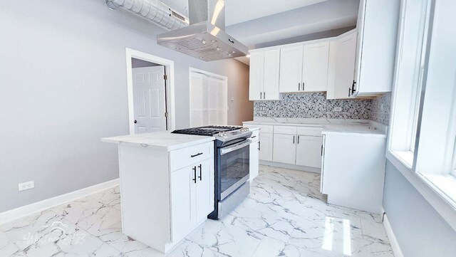 5309 S Bishop St, Chicago, IL 60609 - kitchen featuring island exhaust hood, gas range, light marble finish flooring, tasteful backsplash, and white cabinetry