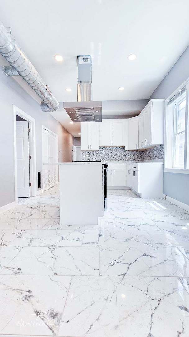 5309 S Bishop St, Chicago, IL 60609 - kitchen featuring white cabinetry, recessed lighting, and decorative backsplash