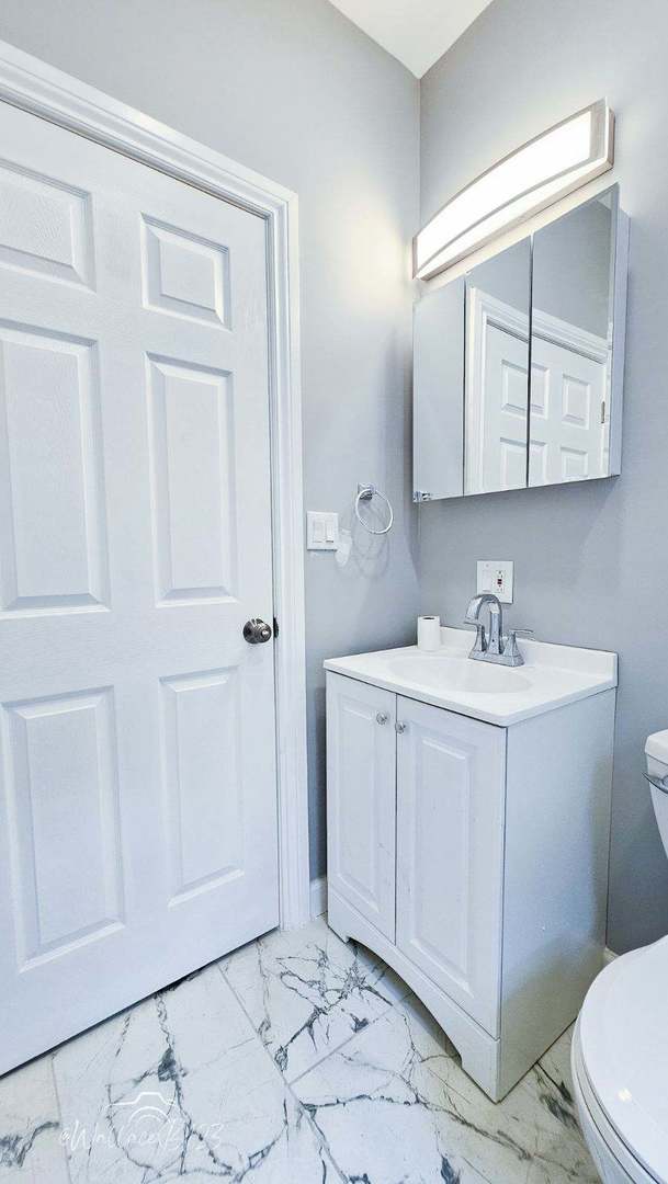 5309 S Bishop St, Chicago, IL 60609 - half bathroom with marble finish floors and vanity