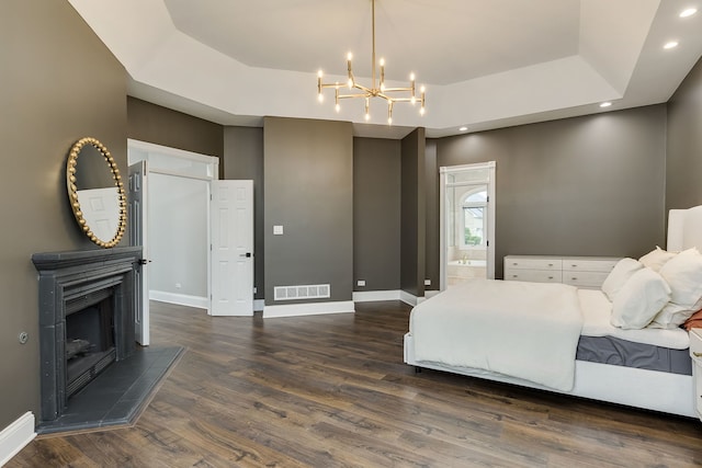 7 Loblolly Ct, Lemont, IL 60439 - bedroom with wood finished floors, a chandelier, a tray ceiling, a tile fireplace, and recessed lighting