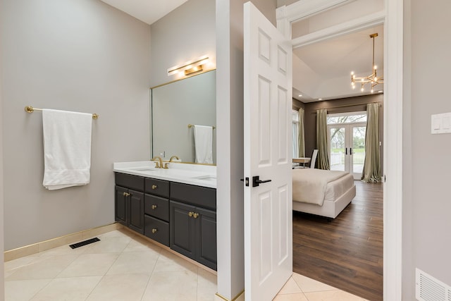 7 Loblolly Ct, Lemont, IL 60439 - bathroom featuring ensuite bath, double vanity, french doors, a chandelier, and tile patterned flooring