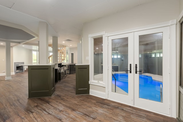 7 Loblolly Ct, Lemont, IL 60439 - interior space featuring french doors, dark wood-type flooring, light countertops, open floor plan, and a center island