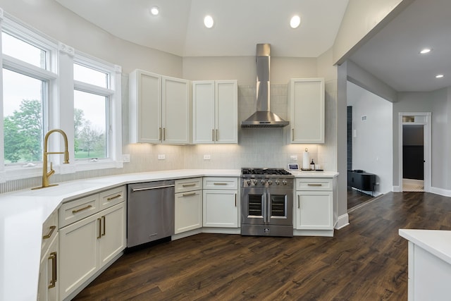 7 Loblolly Ct, Lemont, IL 60439 - kitchen featuring appliances with stainless steel finishes, wall chimney range hood, decorative backsplash, dark wood-style floors, and light countertops