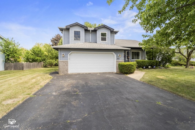 3411 Harris Dr, Joliet, IL 60431 - view of front of house with driveway, brick siding, and a garage