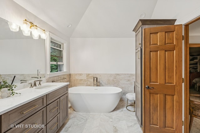 1909 Bridle Ct, Saint Charles, IL 60174 - bathroom featuring vanity, a freestanding tub, a wainscoted wall, lofted ceiling, and marble finish floors