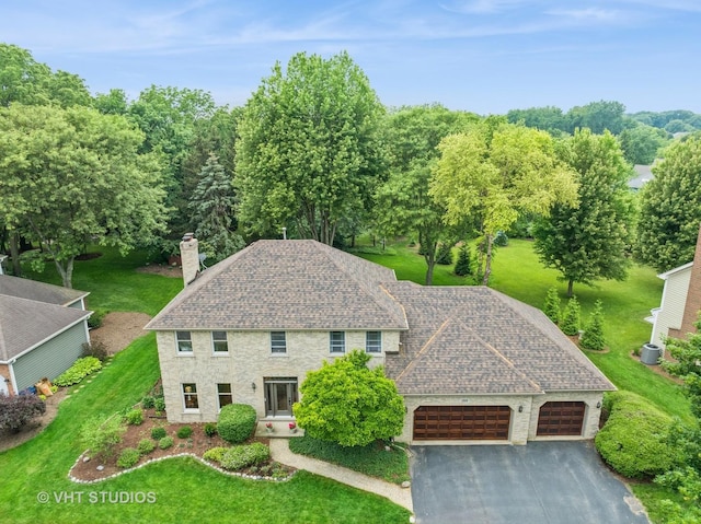 1909 Bridle Ct, Saint Charles, IL 60174 - view of front of property with a garage, a chimney, asphalt driveway, a front lawn, and a shingled roof
