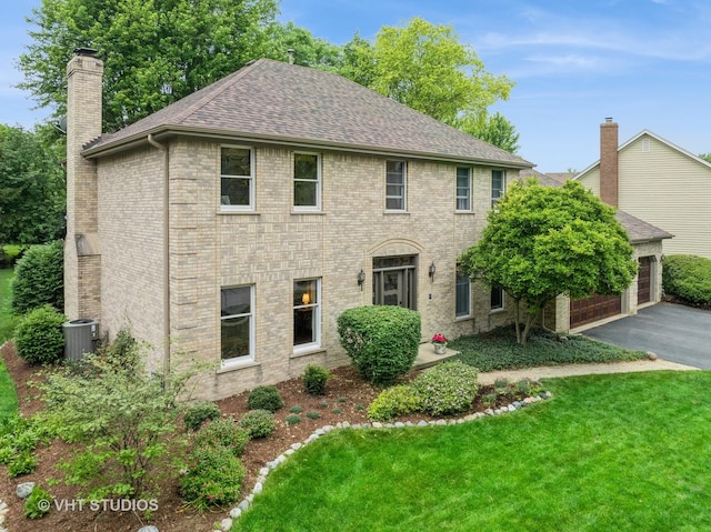 1909 Bridle Ct, Saint Charles, IL 60174 - colonial home with a chimney, roof with shingles, brick siding, a front lawn, and driveway