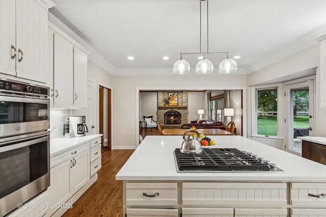 1909 Bridle Ct, Saint Charles, IL 60174 - kitchen with stainless steel appliances, light countertops, a brick fireplace, open floor plan, and recessed lighting