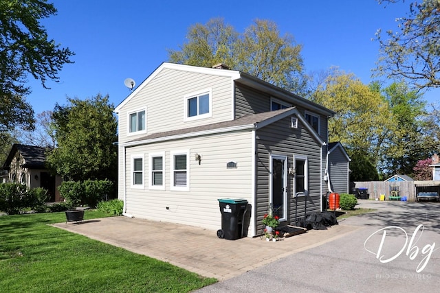 34119 N Hainesville Rd, Round Lake, IL 60073 - back of house with a lawn, a patio, and a chimney