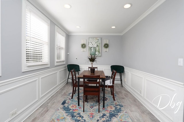 34119 N Hainesville Rd, Round Lake, IL 60073 - dining area featuring light wood-style flooring, recessed lighting, ornamental molding, wainscoting, and a decorative wall