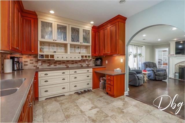 34119 N Hainesville Rd, Round Lake, IL 60073 - kitchen with stainless steel countertops, arched walkways, decorative backsplash, open floor plan, and ornamental molding
