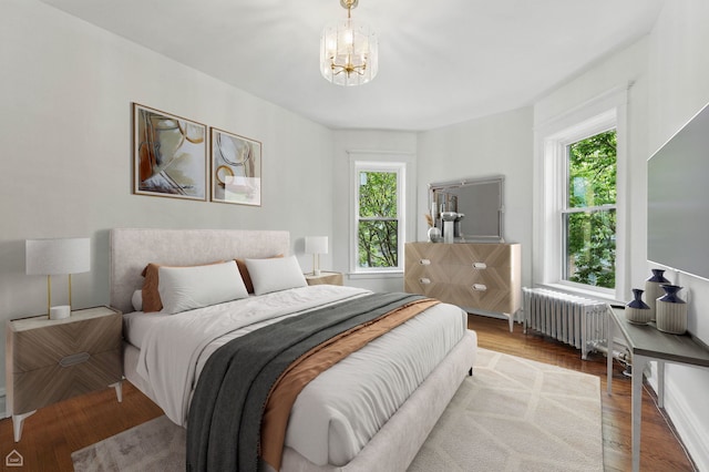 1235 E 53rd St Unit 3, Chicago, IL 60615 - bedroom with radiator, a chandelier, and wood finished floors