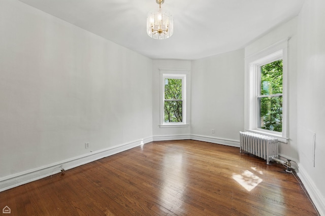 1235 E 53rd St Unit 3, Chicago, IL 60615 - spare room featuring radiator, a chandelier, and wood finished floors