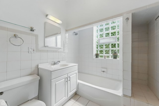 1235 E 53rd St Unit 3, Chicago, IL 60615 - bathroom with tile walls, vanity, tile patterned floors, and shower / washtub combination