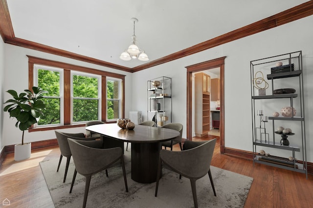 1235 E 53rd St Unit 3, Chicago, IL 60615 - dining space featuring crown molding, wood-type flooring, and a chandelier