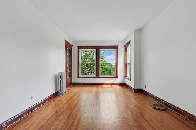 1235 E 53rd St Unit 3, Chicago, IL 60615 - unfurnished room featuring radiator and light wood-style flooring