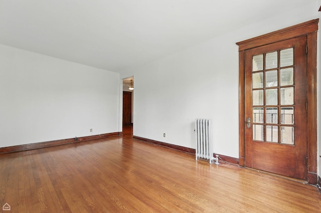 1235 E 53rd St Unit 3, Chicago, IL 60615 - spare room featuring radiator heating unit and wood finished floors