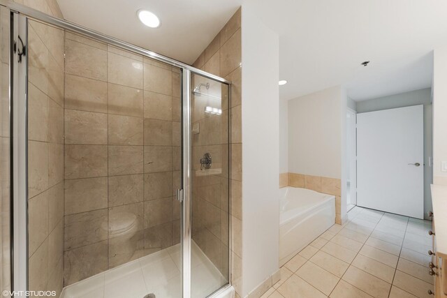 57 E Delaware Pl Unit 2901, Chicago, IL 60611 - bathroom with a garden tub, tile patterned flooring, a stall shower, and recessed lighting
