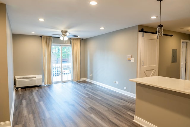 535 E Jefferson St Unit 2C, Bensenville, IL 60106 - unfurnished living room with ceiling fan, a barn door, electric panel, dark wood-style flooring, and recessed lighting