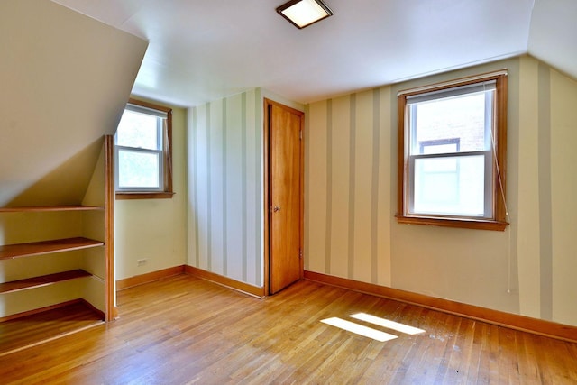 7931 W Metropole St, Elmwood Park, IL 60707 - additional living space with light wood-type flooring, lofted ceiling, and wallpapered walls