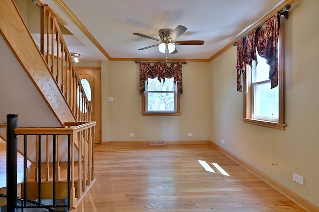 7931 W Metropole St, Elmwood Park, IL 60707 - unfurnished room with light wood-style flooring, a ceiling fan, stairs, and crown molding