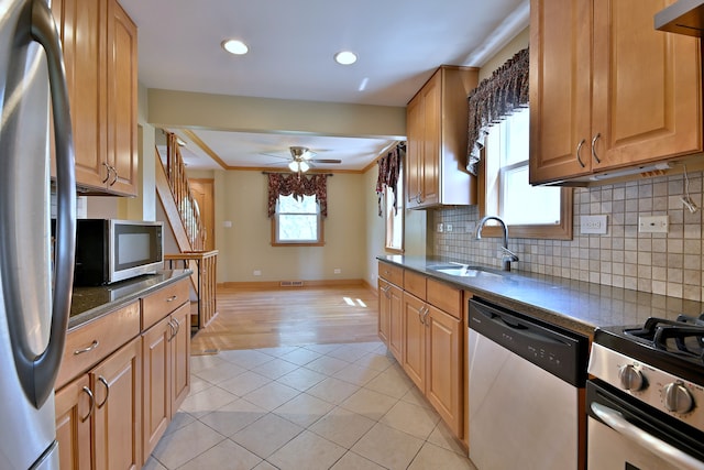 7931 W Metropole St, Elmwood Park, IL 60707 - kitchen featuring appliances with stainless steel finishes, dark countertops, tasteful backsplash, ceiling fan, and crown molding