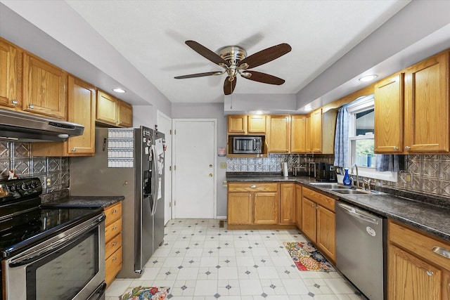 302 S Orr Dr, Normal, IL 61761 - kitchen with stainless steel appliances, under cabinet range hood, a ceiling fan, light flooring, and decorative backsplash