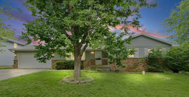 302 S Orr Dr, Normal, IL 61761 - obstructed view of property featuring brick siding, concrete driveway, and a front yard