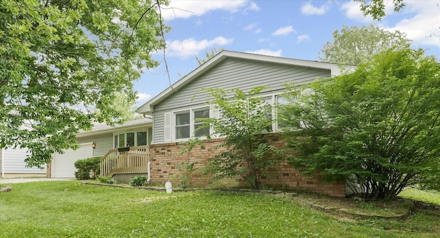302 S Orr Dr, Normal, IL 61761 - view of home's exterior featuring brick siding, an attached garage, and a lawn