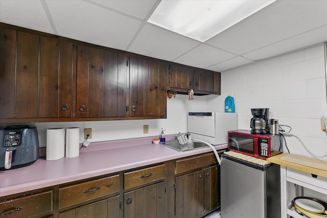 302 S Orr Dr, Normal, IL 61761 - kitchen featuring light countertops, dark brown cabinetry, and a drop ceiling