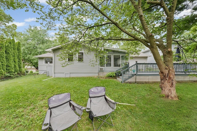 302 S Orr Dr, Normal, IL 61761 - back of house with a deck, a lawn, and a sunroom