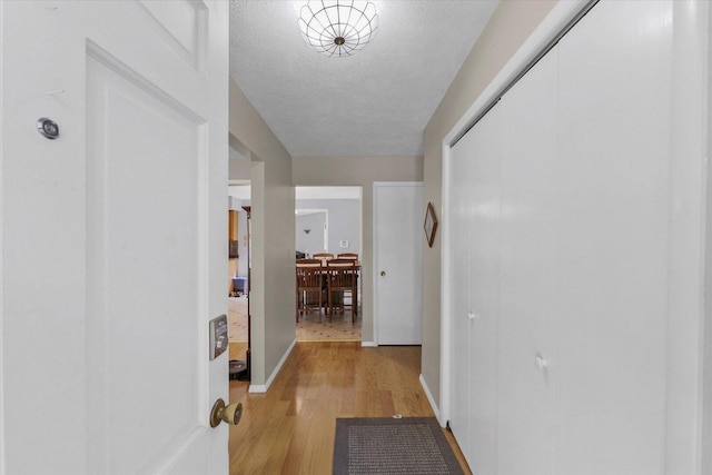 302 S Orr Dr, Normal, IL 61761 - hallway with light wood-type flooring and a textured ceiling