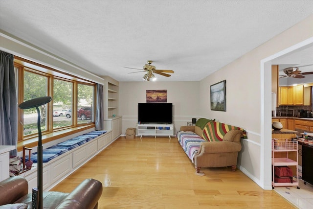 302 S Orr Dr, Normal, IL 61761 - living area featuring ceiling fan, a textured ceiling, light wood-type flooring, and built in features